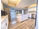 Modern kitchen with island, stainless steel appliances, and light grey vinyl flooring at 1032 Morning Sun Way, Las Vegas, NV 89110