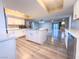 Modern kitchen with island, stainless steel appliances, and light grey vinyl flooring at 1032 Morning Sun Way, Las Vegas, NV 89110
