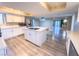 Modern kitchen with island, stainless steel appliances, and light grey vinyl flooring at 1032 Morning Sun Way, Las Vegas, NV 89110