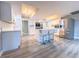 Modern kitchen with island, stainless steel appliances, and light grey vinyl flooring at 1032 Morning Sun Way, Las Vegas, NV 89110