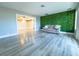 Living room with hardwood floors and green accent wall at 1032 Morning Sun Way, Las Vegas, NV 89110