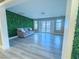 Living area with a comfy couch and a green wall feature at 1032 Morning Sun Way, Las Vegas, NV 89110