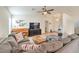 Living room with L-shaped sectional, media console, and large TV at 1043 Oak Shade Ln, Henderson, NV 89015