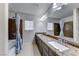 Bathroom with double sinks, granite countertop and a bathtub at 10598 Aphrodite St, Las Vegas, NV 89183