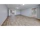 Spacious bedroom with wood-look floors and access to a private bathroom at 10598 Aphrodite St, Las Vegas, NV 89183