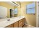 Double vanity bathroom with large mirror and tile flooring at 11248 Newbury Hills Ave, Las Vegas, NV 89138