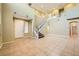 Two-story living room with tile floors and a staircase at 11248 Newbury Hills Ave, Las Vegas, NV 89138