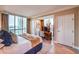 Bedroom with king bed, city view, and an office area at 135 E Harmon Ave # 2302, Las Vegas, NV 89109