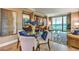 Modern dining area with a glass table and chairs, near the living room and kitchen at 135 E Harmon Ave # 2302, Las Vegas, NV 89109