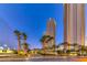 Residential building entrance at night with palm trees at 135 E Harmon Ave # 2302, Las Vegas, NV 89109