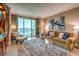 Spacious living room with floor to ceiling windows, couch and city views at 135 E Harmon Ave # 2302, Las Vegas, NV 89109