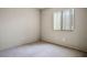 Cozy bedroom with neutral carpet, a single window, and tan walls at 1905 Rose Coral Ave, Las Vegas, NV 89106