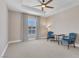 Spacious bedroom with ceiling fan, large window, and carpeted floor at 30 Strada Di Villaggio # 151, Henderson, NV 89011