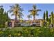 Community pool area with lush landscaping and palm trees at 30 Strada Di Villaggio # 151, Henderson, NV 89011