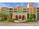 Elegant condo building with Spanish-style architecture, fountain, and lush landscaping at 30 Strada Di Villaggio # 151, Henderson, NV 89011