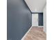 Hallway with dark blue walls and hardwood floors at 30 Strada Di Villaggio # 151, Henderson, NV 89011