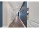 Modern hallway with dark blue accent wall and hardwood floors at 30 Strada Di Villaggio # 151, Henderson, NV 89011