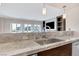 Modern kitchen with a large island and granite countertops at 30 Strada Di Villaggio # 151, Henderson, NV 89011