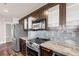 Modern kitchen with stainless steel appliances and granite countertops at 30 Strada Di Villaggio # 151, Henderson, NV 89011