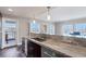 Modern kitchen with stainless steel appliances and granite countertops, and balcony access at 30 Strada Di Villaggio # 151, Henderson, NV 89011