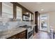 Modern kitchen with stainless steel appliances and granite countertops, and balcony access at 30 Strada Di Villaggio # 151, Henderson, NV 89011