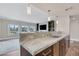 Modern kitchen with a large island and granite countertops at 30 Strada Di Villaggio # 151, Henderson, NV 89011