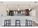 Modern kitchen with breakfast bar and dark wood cabinets at 30 Strada Di Villaggio # 151, Henderson, NV 89011