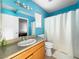 Small bathroom with teal walls, single sink vanity, and shower at 3350 Stacey Lyn Dr, Las Vegas, NV 89117