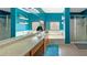 Bathroom with teal walls, double sinks, and a bathtub at 3350 Stacey Lyn Dr, Las Vegas, NV 89117