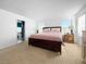 Main bedroom with a king-size bed, ensuite bathroom, and large windows at 3350 Stacey Lyn Dr, Las Vegas, NV 89117