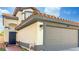 Two-story house with gray garage door and Spanish tile roof at 3350 Stacey Lyn Dr, Las Vegas, NV 89117