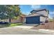 Two-story house with dark blue garage door and desert landscaping at 3350 Stacey Lyn Dr, Las Vegas, NV 89117