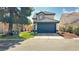 Two-story house with dark blue garage door and landscaping at 3350 Stacey Lyn Dr, Las Vegas, NV 89117