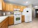 Kitchen with white appliances and light wood cabinets at 3350 Stacey Lyn Dr, Las Vegas, NV 89117