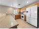 L-shaped kitchen with white appliances and light wood cabinets at 3350 Stacey Lyn Dr, Las Vegas, NV 89117