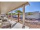 Covered patio, offering a shaded relaxing space with desert landscaping at 3409 Cantura Bluff Ave, North Las Vegas, NV 89031