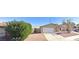 Single story house with a white garage door and landscaped yard at 3614 Calmosa, Las Vegas, NV 89103