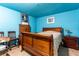 Basement bedroom with hardwood floors and a wood bed frame at 362 Rainbow Canyon Blvd, Las Vegas, NV 89124