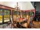 Elegant dining room with dark wood table and chairs, chandelier, and access to a deck at 362 Rainbow Canyon Blvd, Las Vegas, NV 89124