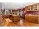 Large kitchen with granite island, wood cabinets, and breakfast nook at 362 Rainbow Canyon Blvd, Las Vegas, NV 89124