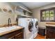 Bright laundry room with washer, dryer, and granite countertop at 362 Rainbow Canyon Blvd, Las Vegas, NV 89124