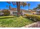 Two-story house with a large tree and lush green lawn at 3940 Spencer St, Las Vegas, NV 89119