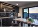 Modern wet bar with granite countertops and city views at 410 Tranquil Peak Ct, Henderson, NV 89012