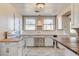 Kitchen with white cabinets, butcher block island, and sink at 429 Ash St, Boulder City, NV 89005