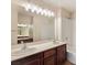 Bathroom featuring double sinks, a large mirror, and a shower over the tub at 43 E Agate Ave # 403, Las Vegas, NV 89123
