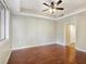 A spacious bedroom with dark wood floors, a ceiling fan, and a tray ceiling at 43 E Agate Ave # 403, Las Vegas, NV 89123