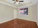 Bedroom with hardwood floors, tray ceiling, and view of colorful buildings at 43 E Agate Ave # 403, Las Vegas, NV 89123