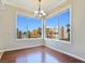 Cozy dining area with hardwood floors, a chandelier, and large windows offering views of the surrounding neighborhood at 43 E Agate Ave # 403, Las Vegas, NV 89123