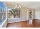 Bright dining room with hardwood floors, windows with natural light, chandelier, and access to outdoor balcony at 43 E Agate Ave # 403, Las Vegas, NV 89123