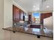 Kitchen with granite countertop bar, tile flooring and stainless steel appliances at 43 E Agate Ave # 403, Las Vegas, NV 89123